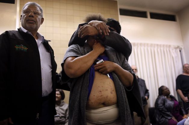 Richmond City Councilman Corky Boozé (left) asks the Richmond mayor to look at the bedbug bites that a resident, comforted by Thomas Hunt, says she received while living in the Hacienda public housing complex. Photo: Lacy Atkins, The Chronicle